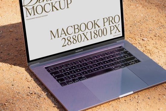 Realistic MacBook Pro mockup on sandy ground showcasing screen resolution for digital asset designers, technology, outdoor, realistic, device display.