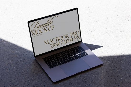 Laptop mockup on concrete floor displaying screen with elegant typography design, ideal for showcasing web and app designs for designers.