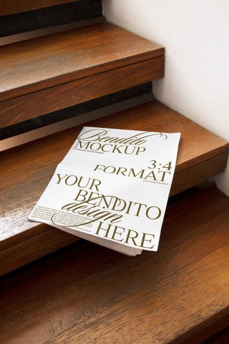 Bendito tabloid newspaper mockup on wooden stairs with gold serif typography
