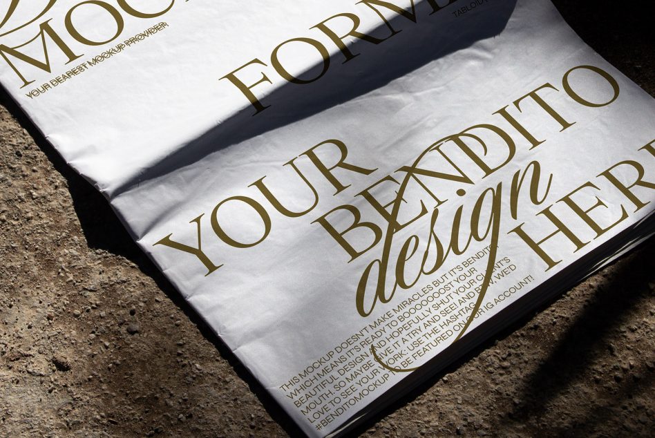 Elegant gold typography magazine mockup with textured paper shadow on concrete surface ideal for graphic design presentations.