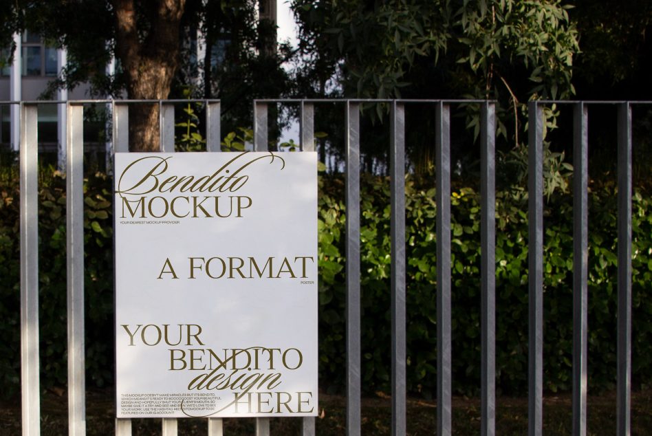Poster mockup hanging on metal fence with trees in background