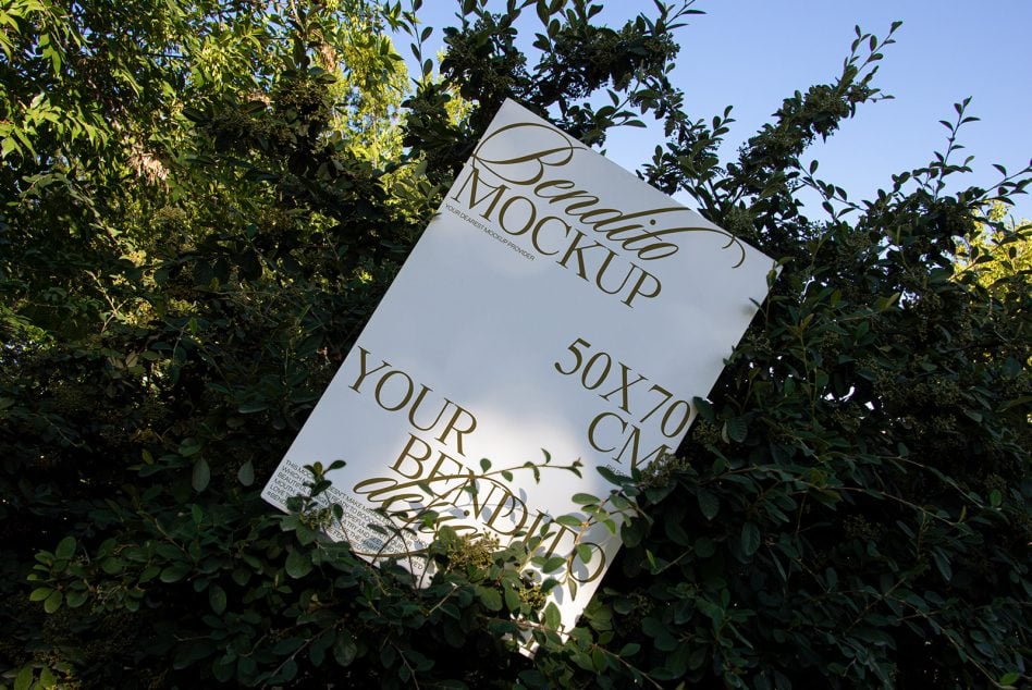 Bendito mockup poster tilted between dense green bushes with bright daylight overhead