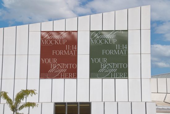 Two poster mockups displayed on a modern building exterior for showcasing design works, with clear sky background, ideal for graphic designers.