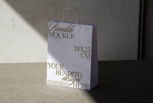 Paper shopping bag mockup in natural light, showcasing customizable design space for logos, with dimensions label, ideal for graphic designers.