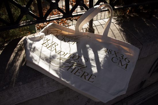 Elegant tote bag mockup in sunlight, realistic shadows, outdoor setting, perfect for showcasing bag designs and patterns.
