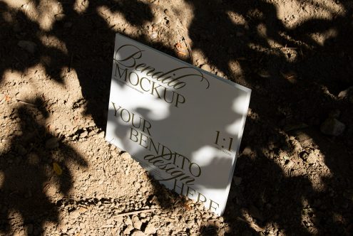 Elegant mockup of a square record sleeve lying on a textured ground with natural shadows, perfect for presenting album designs for designers.