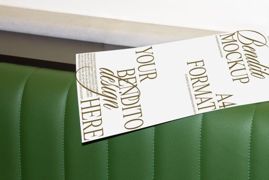 Elegant flyer mockup on green leather surface presenting design space, ideal for showcasing graphic designs in a realistic setting for designers.