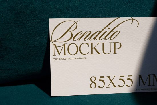 Elegant business card mockup featuring golden typography on white textured paper with a dark blue background, showcasing design and print quality.