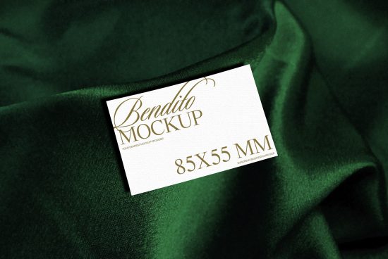 Elegant business card mockup on green fabric texture, showcasing design and typography for creative branding.