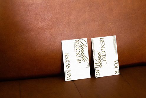 Professional business card mockup on leather surface for presentation, showcasing elegant design, realistic shadows, editable 85x55 mm size.