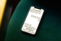 iPhone 13 on teal fabric with warm amber lighting from side