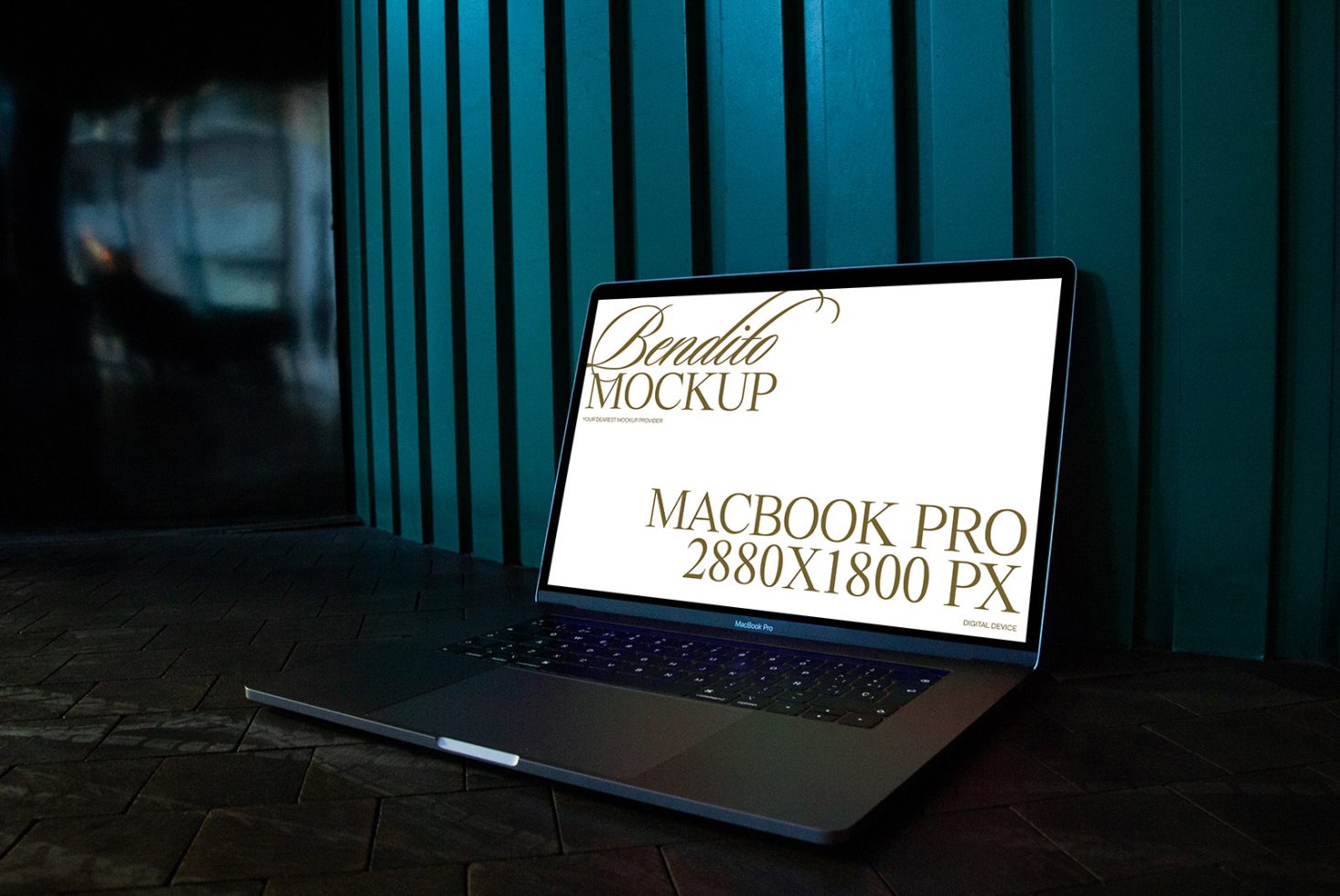 Laptop mockup on dark brick floor against blue striped wall displaying screen with Bendito Mockup MacBook Pro 2880x1800 px text.