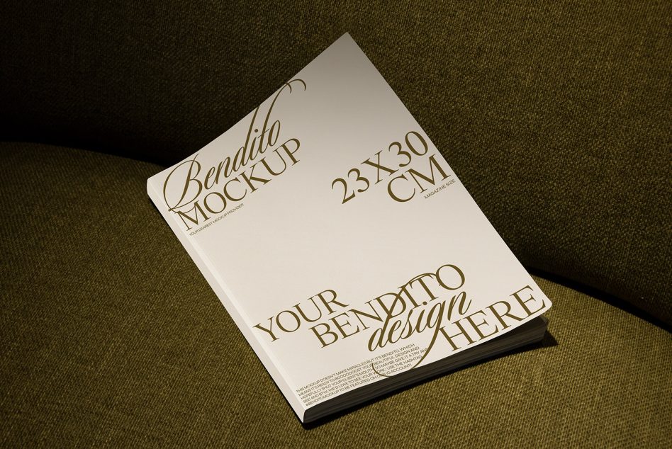 Single magazine mockup 23x30cm tilted on green textile background