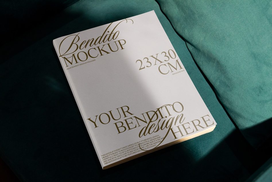 Magazine mockup flat lay on teal fabric showing cream cover with gold typography