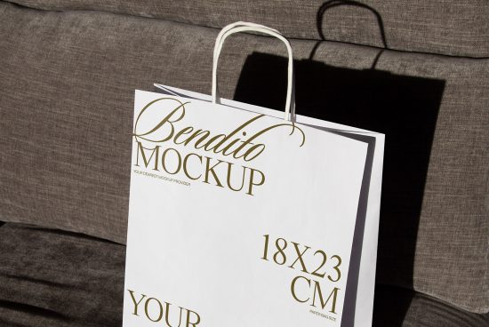 Elegant paper bag mockup with golden typography on a textured background, perfect for showcasing branding designs to clients.