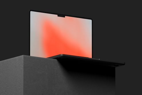 Laptop screen with warm peach-to-orange gradient, mounted on concrete base
