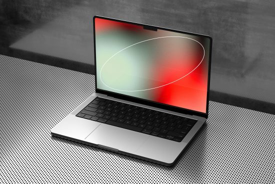 Modern laptop mockup on textured surface with vibrant screen design, ideal for presentations and web design showcases, perfect for asset portfolio.