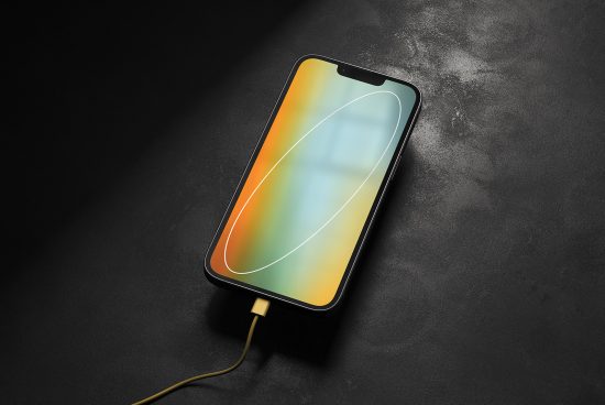 Smartphone mockup on dark textured background with vibrant screen and charging cable, ideal for showcasing app designs or wallpapers.