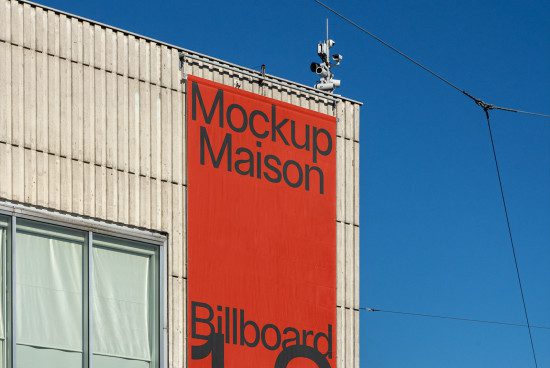 Urban billboard mockup on building facade under clear blue sky for outdoor advertising design presentation.