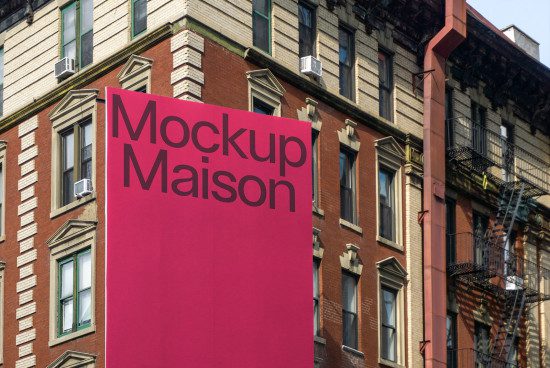Urban billboard mockup on a vibrant pink background against an old apartment building, perfect for graphic designers.