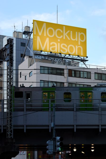 Urban billboard mockup on a building above a train station with a clear sky, ideal for presenting outdoor advertising designs.