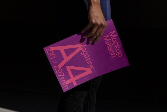 Person holding a purple magazine mockup with text design, demonstrating a realistic print template for graphic designers.