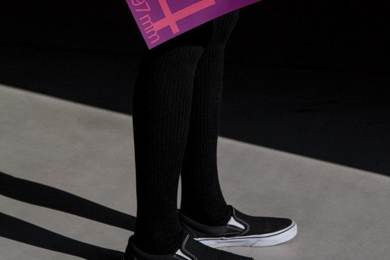Person standing in graphic shadows, stylish urban streetwear mockup with visible sneaker, dynamic light and contrast design elements.