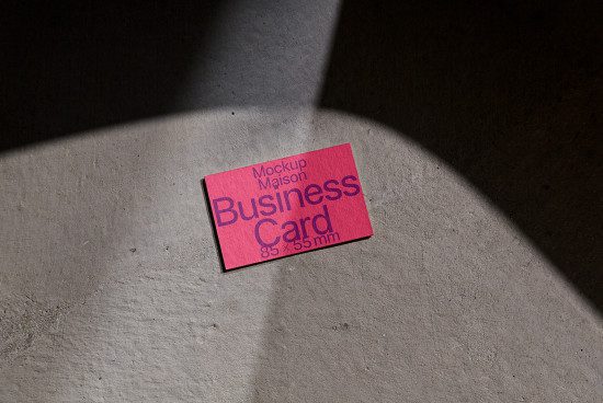Business card mockup with natural shadows on concrete surface, ideal for designers to showcase professional branding designs.