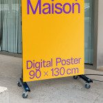 Large digital poster mockup on wheels outdoor display for advertising design, urban setting, 90x130 cm template for graphic designers.