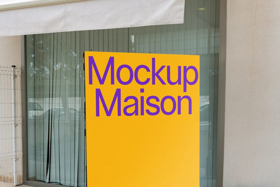Large yellow poster mockup mounted on storefront window with green doors