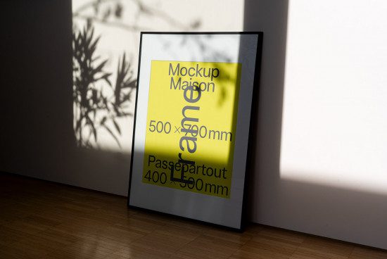 Poster frame mockup in sunny room with natural plant shadow, showcasing design space, for graphics and templates display.