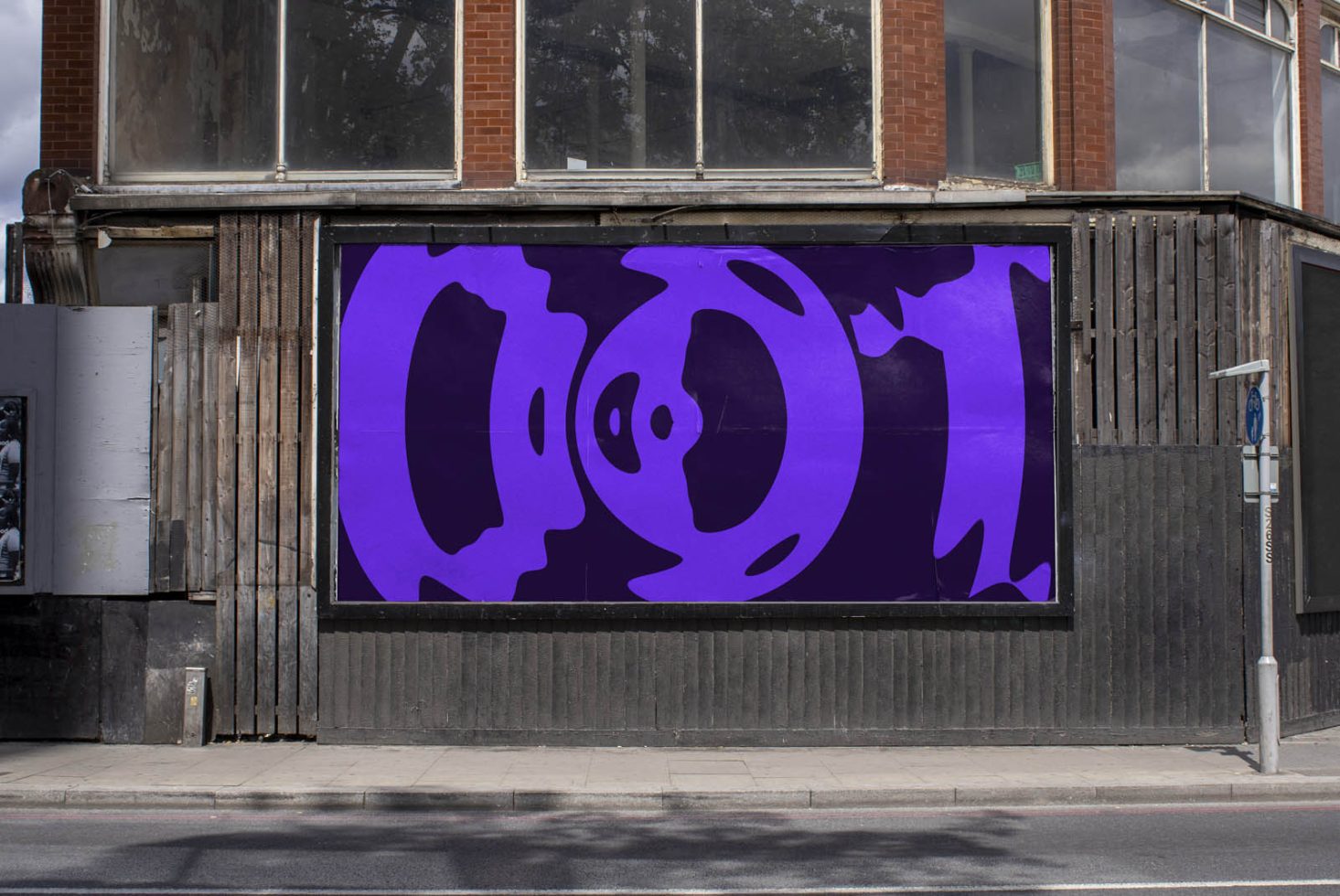 Urban billboard mockup with bold purple abstract design, perfect for designers to showcase advertising graphics in a realistic street setting.