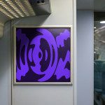 Urban transit abstract graphic art poster mockup displayed in train carriage, featuring dynamic purple shapes for contemporary design projects.