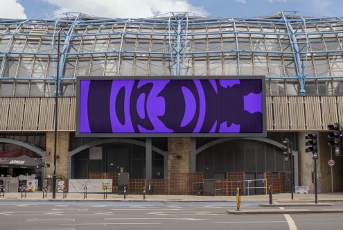 Urban billboard mockup displaying purple abstract design, set against a modern building facade, ideal for designer presentations.