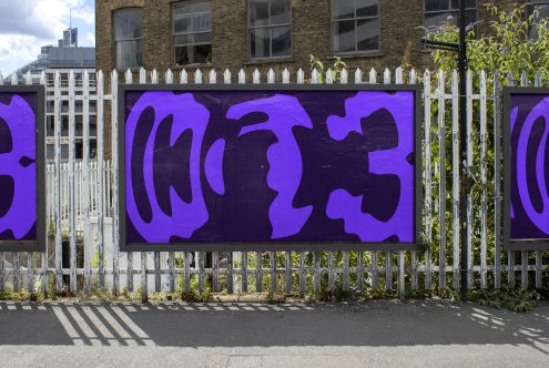 Urban street art banner mockup with bold purple abstract graffiti design on fence, ideal for presentation of graphic designs.