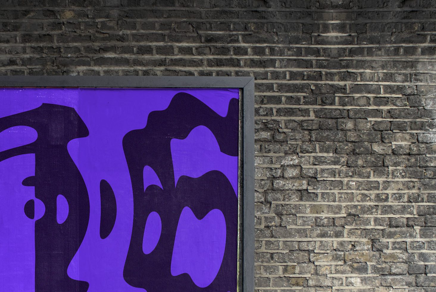 Abstract purple graffiti art on urban brick wall texture, creative street art graphic background for contemporary design mockup.