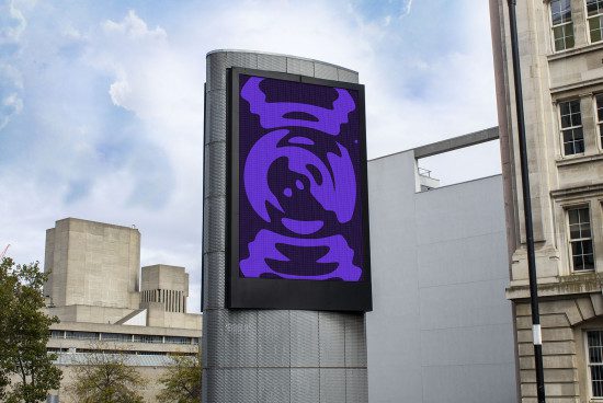 Urban billboard mockup displaying a bold purple abstract graphic design advert, set against a bustling cityscape backdrop for designers.