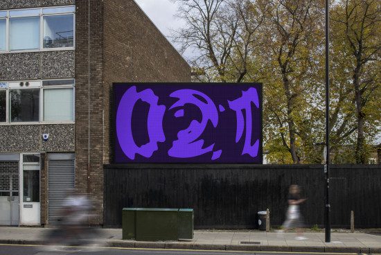 Digital billboard mockup on urban street with dynamic purple abstract design, showcasing outdoor advertising space for designers.