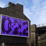 Urban billboard mockup with abstract purple graphic design, clear sky, old buildings and bridge, ideal for outdoor advertising presentation.