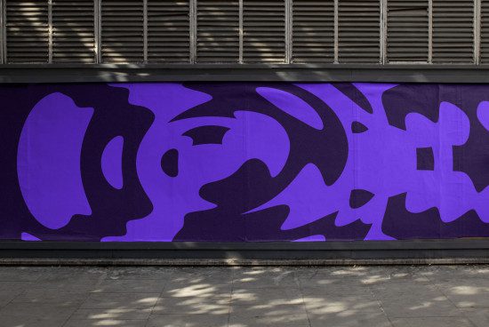 Urban street wall with bold purple abstract graffiti art for graphic design mockups and inspiration.