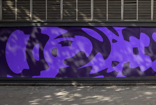 Urban street wall with abstract purple graffiti for graphic mockups, outdoor advertising, and modern design projects.