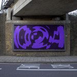 Urban billboard mockup with abstract purple graphic design under a bridge, clear space ready for advertising content, ideal for designers.