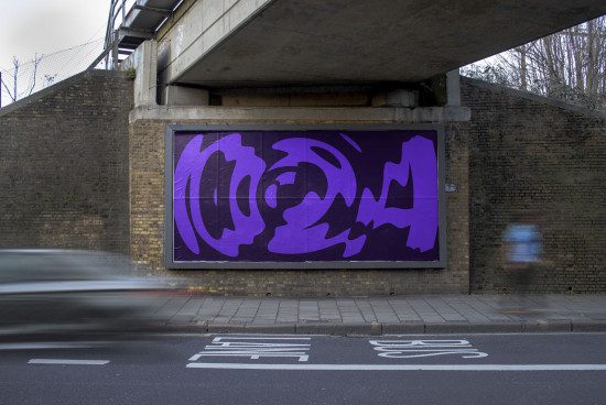Urban billboard mockup with abstract purple graphic design under a bridge, brick wall texture, blurred passing car, street setting.