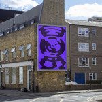 Urban mockup of a large purple billboard with abstract design on a building exterior, ideal for presentations and advertising designs.