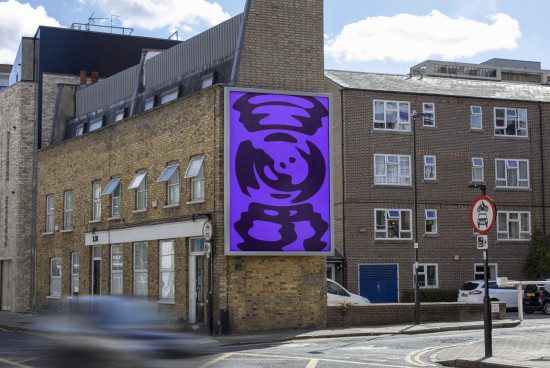 Urban billboard mockup displaying vibrant abstract purple art on a building, with clear sky and city street, great for designers and advertisers.