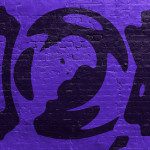 Purple brick wall with abstract graffiti for graphic design projects, trendy urban background texture, suitable for mockups and templates.