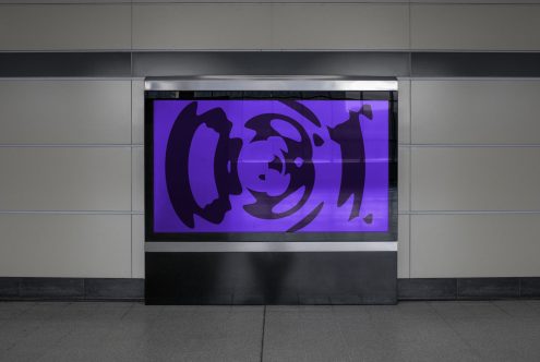 Urban billboard mockup in a subway station with purple abstract advertising graphic design, perfect for presentations and portfolio displays.