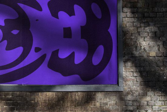 Urban poster mockup on a brick wall showcasing purple graphic design, suitable for designers to display art and designs.