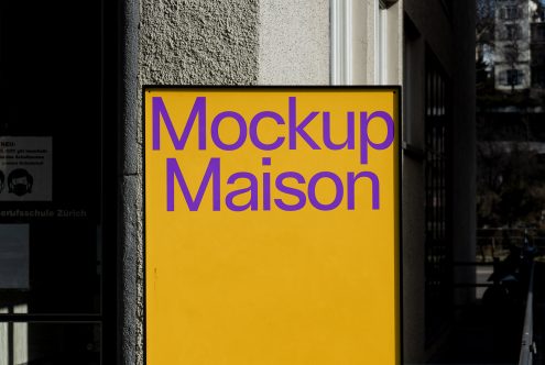 Bold purple text "Mockup Maison" on yellow sign, urban setting, shadow play, ideal for mockup category, showcases typography, signage design.