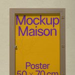 Poster mockup displayed in a glass case on a textured wall, for graphic designers to showcase work, size 50x70cm, easily editable.